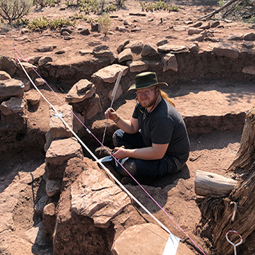 Field school student Ian Farrell is working on an excavation at an archaeological site in Range Creek Canyon